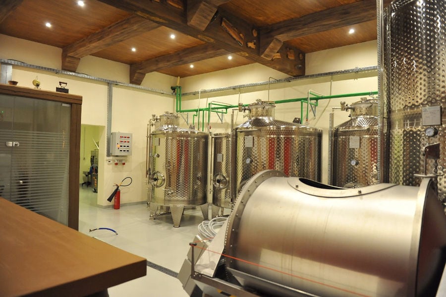 wine storage tanks and grape press machine at 'Piperis Winery' plant
